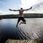 guy jumping into lake